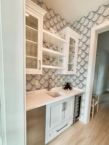 Galley kitchen with bold pattern wallpaper. 